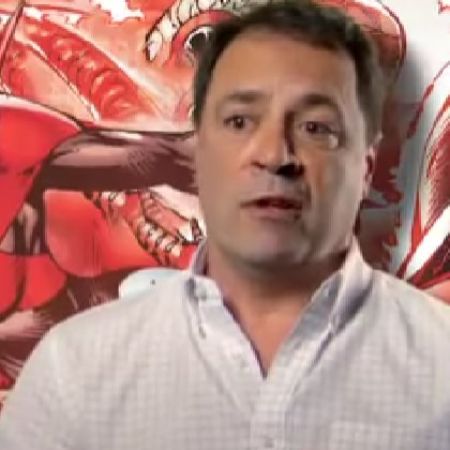 Bob Harras is wearing a white shirt as there is a comic art in the background.